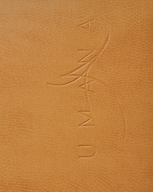 Signature Umana sur tapis de cuir végétalien.